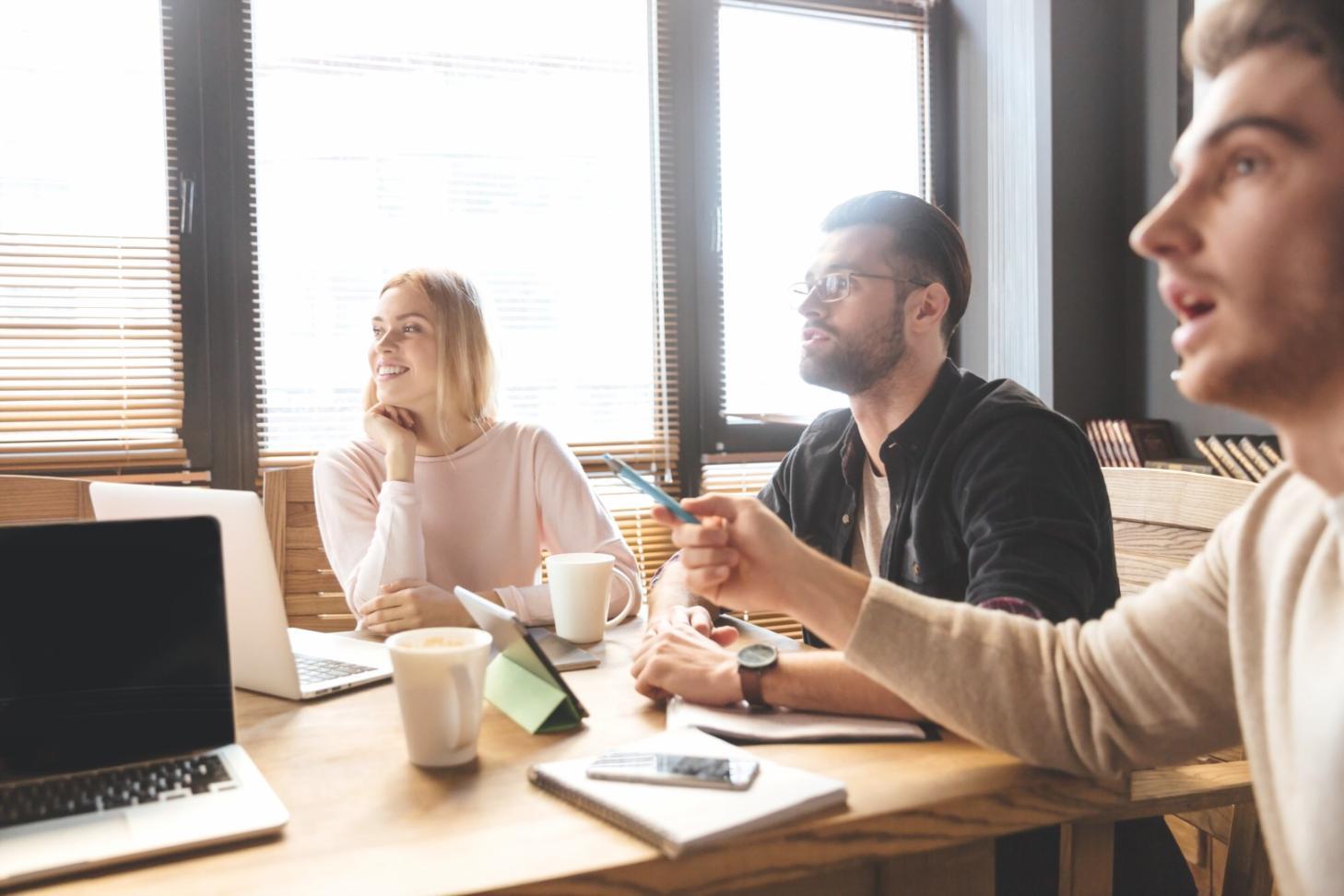 Family reviewing budget documents together at kitchen table